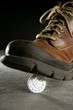 euro currency coin tread by a boot