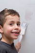 Boy painting a wall