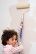 Girl painting a wall