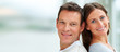 Portrait of young couple standing with their backs together