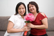 Asian females posing with flowers