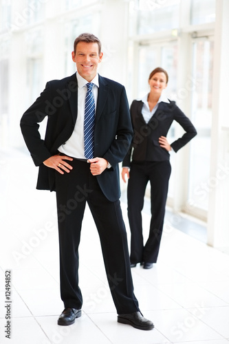 Photo: Portrait of smiling business people standing together Portrait of smiling business people standing together