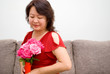 Asian lady looking at roses