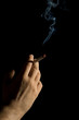 hand holding a smoking cigarette isolated