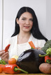 Woman in kitchen with vegetables Woman in kitchen with vegetables