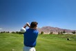 A man swinging a golf club A man swinging a golf club