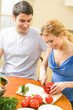 Young couple cooking together with vegetables at home Young couple cooking together with vegetables at home