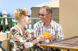 happy old couple enjoying their lunch on the balcony
