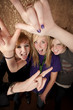 Three Young Girls Making Hand Gestures