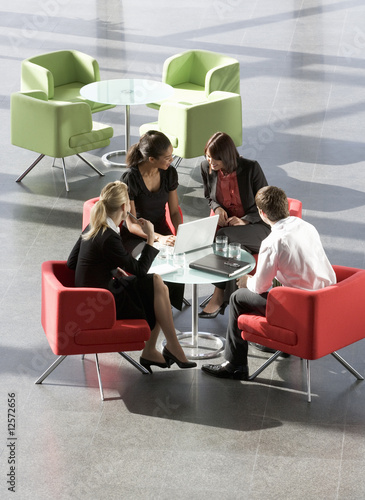 Photo: A group of four business colleagues holding an informal meeting A group of four business colleagues holding an informal meeting