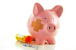 Bandaged Piggy bank with pills(healthcare costs) Bandaged Piggy bank with pills(healthcare costs)