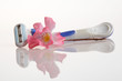 Blue safety razor and flower