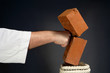 karate man breaking  brick on gray background