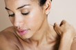 A young woman massaging her shoulder