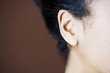 Close-up side view of womans head showing ear and jawline
