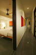 A long passage is seen from the entrance of a bedroom