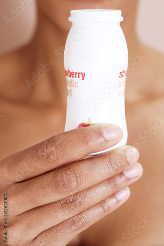 Photo: A woman drinking a probiotic yoghurt drink A woman drinking a probiotic yoghurt drink