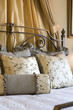 Curtains behind Headboard and Pillows on Bed