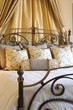 Curtains behind Headboard of Bed with Several Pillows
