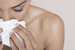 A woman blowing her nose
