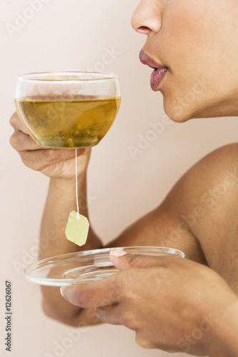 Photo: A woman drinking a cup of herbal tea A woman drinking a cup of herbal tea