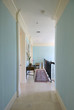 A rug is kept near a handrail of an eclectic house