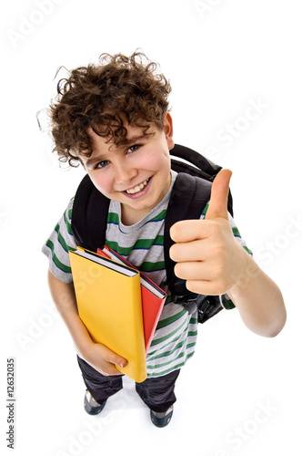 Photo: Young boy holding books, looking up isolated on white Young boy holding books, looking up isolated on white