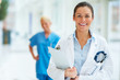Smiling medical doctor with stethoscope and clipboard