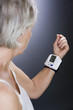 A senior woman with a heart rate monitor on her wrist