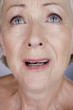 A senior woman crying
