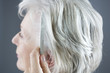 A senior woman combing her hair