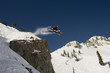 skier jumping cross tips off cliff