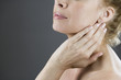 A woman touching her neck