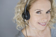 A middle aged woman wearing a headset