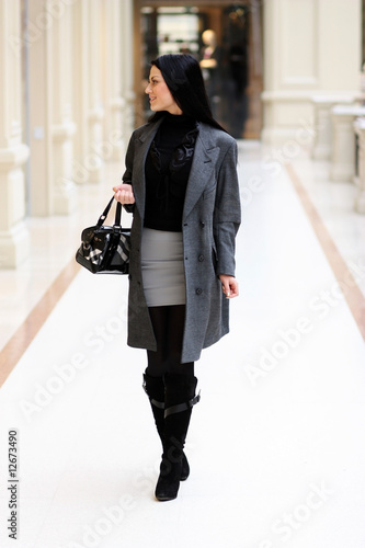 Photo: Young pretty woman standing and smiling in GUM. Moscow, Russia Young pretty woman standing and smiling in GUM. Moscow, Russia
