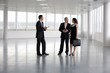 A letting agent showing business people around empty office