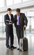 Two businessmen discussing papers