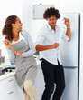 Cute young couple in a playful mood preparing food together