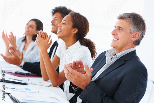Photo: Successful business team clapping their hands Successful business team clapping their hands