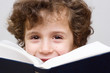 A little boy reading a big book