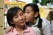 Daughter kissing mother