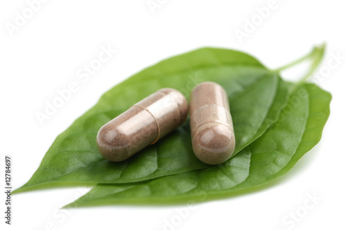 macro of prescription pills over green leaf isolated