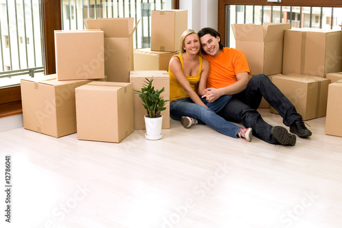 Photo: Couple sitting in new home Couple sitting in new home