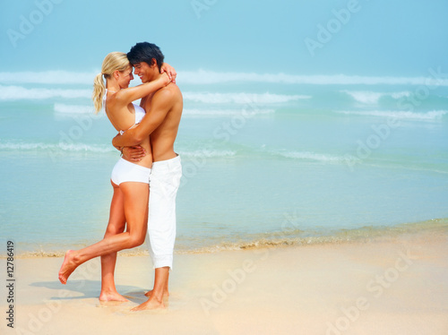 Photo: Full length image of a young couple hugging eachother Full length image of a young couple hugging eachother