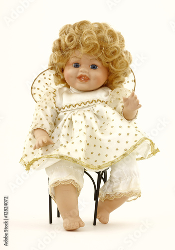 Photo: A baby doll in her own wrought iron chair. A baby doll in her own wrought iron chair.