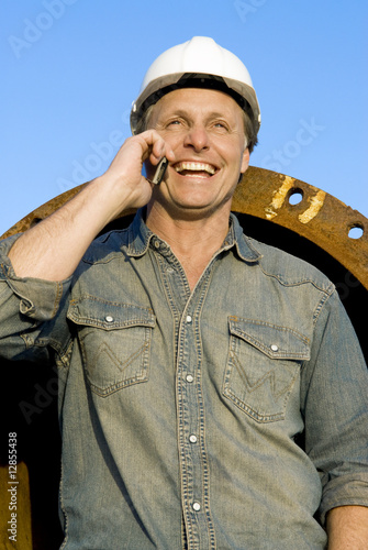 Photo: happy construction worker on cellphone happy construction worker on cellphone