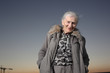 Portrait of a senior woman over sunset sky