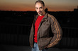 Portrait of a handsome man in brown jacket outdoors