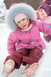 girl rolls down on ice slope