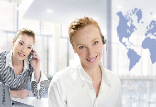 Modern office, two beautiful businesswoman